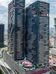 two tall skyscrapers in a city with buildings at Arte Plus Ampang By Awesomestay in Kuala Lumpur