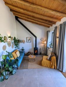 a living room with a blue couch and a fireplace at Finca Bravo in Cortegana +85 photos
