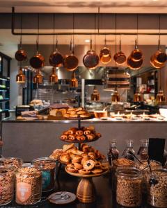 a kitchen with a bunch of food on a table at INK Hotel Amsterdam - MGallery Collection in Amsterdam