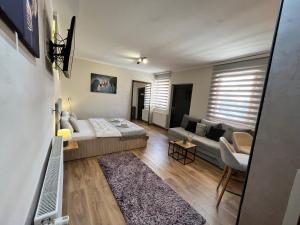 a living room with a bed and a couch at Apartman Irma sweet in Sarajevo