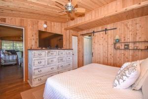 a bedroom with a bed and a dresser with a television at LaLa Land in Dadeville