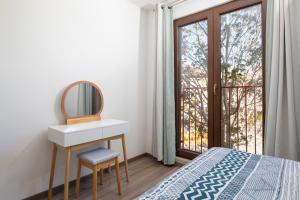 a bedroom with a dressing table and a mirror at City market apartments Pula in Pula