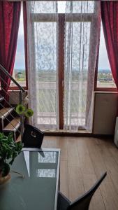 a living room with a glass table and large windows at Panorama Lucano in Altamura