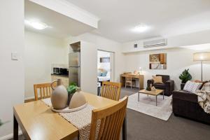 a living room and dining room with a table and chairs at Prized Perth Retreat 1BDR in Perth