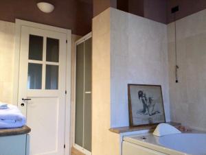 a bathroom with a sink and a toilet and a door at Villa Moglietta in Albaretto Della Torre 