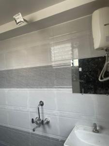 a bathroom with a sink and a mirror on the wall at Hotel Kapish International Solapur 400 mts from Bus Stand and 500 mtr from railway station in Solapur