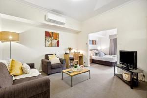 a living room with a couch and a tv and a bed at Perth Premium 1 Bedroom in Perth