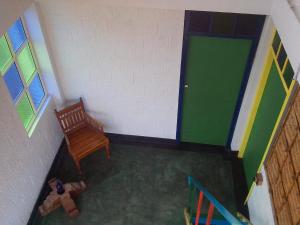 an overhead view of a room with a chair and a door at Adams Wood House Ayurveda Homestay Kochi in Cochin