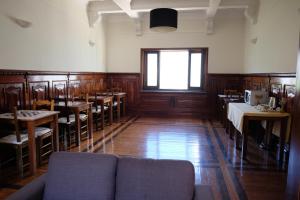 a dining room with a couch and tables and a window at Yellow Inn Aveiro in Aveiro
