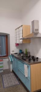 a kitchen with a blue island in a room at La casa di Raffa in Bonassola