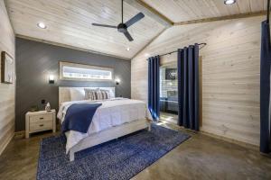 a bedroom with a bed and a ceiling fan at Morning Roast Cabin in Broken Bow