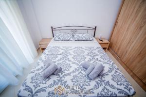 a bedroom with a blue and white bed with two pillows at Polys Polychrono MoodSolutions Living in Polykhrono