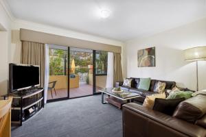 a living room with a couch and a tv at 3BDR 2BTH 1PRK - Northbridge Townhouse in Perth