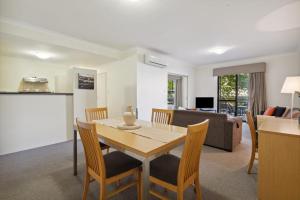 a dining room and living room with a table and chairs at 2BDR 1BTH 1PRK - Northbridge Magic in Perth