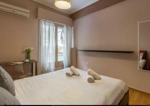 sypialnia z łóżkiem z 2 kapciami w obiekcie Holodek Apartments Goudi Ground & Semi w Atenach