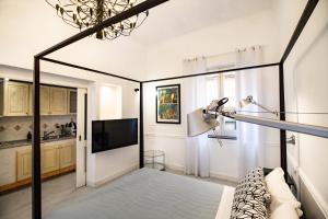 - un salon avec une télévision et un canapé dans l'établissement Iommella luxury flat - Schifano, à Sant'Agnello