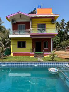 a house and a swimming pool in front of a house at Anand Heritage Villa in Nagaon