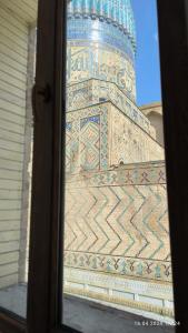 a view of a building through a window at Bibikhanum Hotel in Samarkand