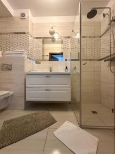 a bathroom with a sink and a shower at SPOT JURATA in Jurata