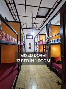 a room with bunk beds with the words music dont bed in room at SEMERU HOSTEL MALANG in Malang