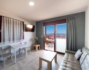 a living room with a couch and a table at Excess Pansion in Lefkada Town