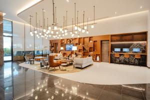 a large living room with a chandelier at Revier Hotel - Dubai in Dubai