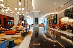 a lobby of a store with chairs and tables at Revier Hotel - Dubai in Dubai