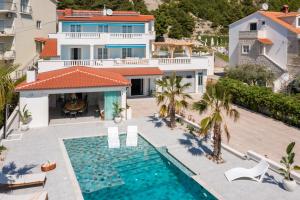 an aerial view of a house with a swimming pool at New Luxury Beach Villa in Duće +97 photos