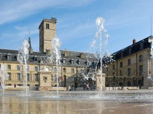 a fountain in a square in front of a building at Novotel Dijon Sud in Dijon