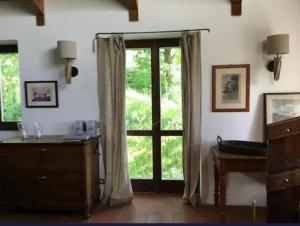 a room with a large window and a dresser at Lago di Como - home holiday in Zelbio