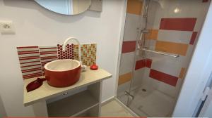 a bathroom with a sink and a shower at DUNØ Suites in Dun-le-Palestel +5 photos