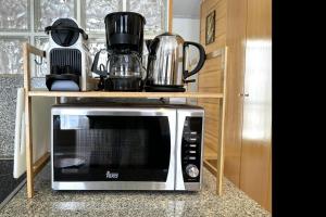 a microwave sitting on a counter in a kitchen at Loft with terrace in Tossa in Tossa de Mar +16 photos