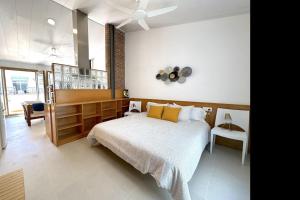 a bedroom with a bed and a ceiling fan at Loft with terrace in Tossa in Tossa de Mar