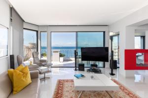 a living room with a view of the ocean at Aria, Lux seafront apt with White Tower view in Thessaloniki