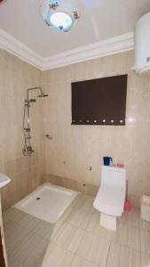a bathroom with a shower and a toilet in it at Sohna's Paradise Residence 
