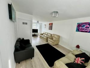 a living room with a couch and couches in it at Cozy Home in Twickenham