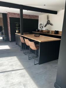 a kitchen with a wooden table and stools at Suite l Instant suspendu maison 25m2 avec coin salon Wifi Netflix Maison Like and Love Duclair in Duclair +20 photos
