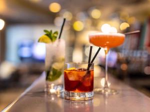two cocktails sitting on a counter in a bar at ibis London City - Shoreditch in London