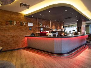 a bar in a restaurant with a brick wall at ibis London City - Shoreditch in London