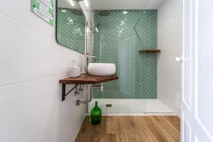 a bathroom with a sink and a mirror at Lost Lobster Guest House in Albufeira +28 photos