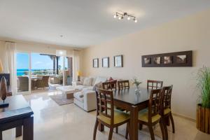 een woonkamer met een tafel en stoelen en een bank bij Malibu B3 Luxury 2BR Panoramic Sea View Ref 245 in Fuengirola