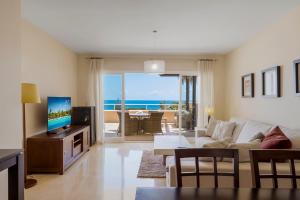 a living room with a couch and a tv at Malibu B3 Luxury 2BR Panoramic Sea View Ref 245 in Fuengirola