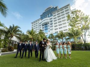 a wedding party posing in front of a hotel at Novotel Phuket City Phokeethra in Phuket Town