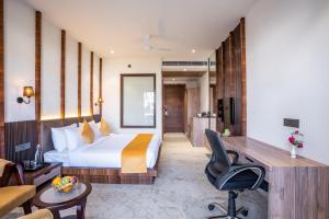 a hotel room with a bed and a desk at Shervani Pebbles And Pines Corbett in Rāmnagar