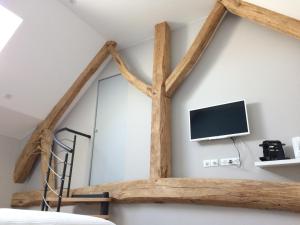 a room with a bed and a tv on a wall at Le Clos n°5 in Villy-le-Moutier