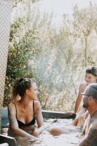 a group of people sitting in a bath tub at Mont Rouge Cottage in Tulbagh