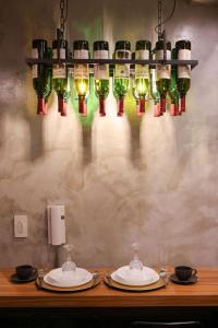a chandelier with wine glasses and plates on a table at Kensal Industrial - Air Residences in Manila