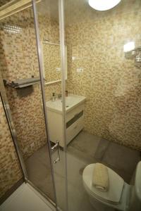 a bathroom with a shower and a toilet and a sink at Casa Ati.ko Beach Apartment in Cotillo +19 photos