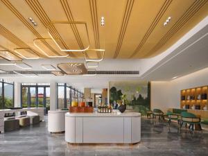 a lobby with a bar and some chairs and tables at Hilton Garden Inn Guilin Yangshuo in Guilin