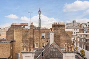 an old brick building with a tower on top of it at City Chic 3 Bedroom, 3 Bathroom Luxury Living 7 in London